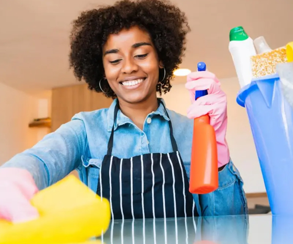 Professional cleaners mopping a wooden floor with a supply bucket
