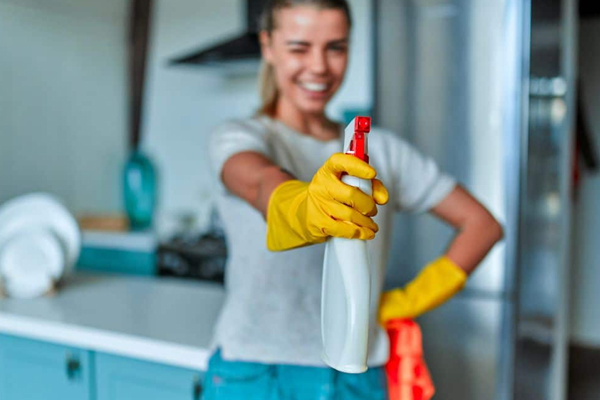 Cleaners spraying and wiping a window