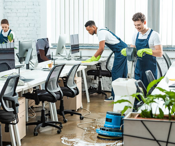 Commercial Cleaners using floor buffers and wiping office desks