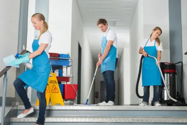 Commercial Cleaners buffing floors and wiping office desks